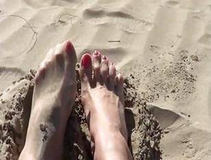 T-girl shows her manicured feet and booty at the beach - SheMaleX.net - shemalex.net